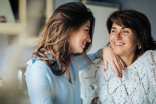 Two Women Smiling At Each Other